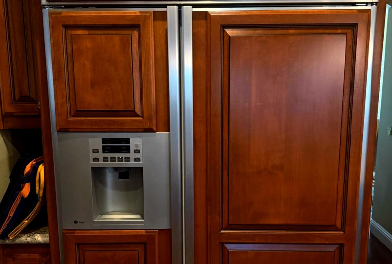 On-site diagnostics of a built-in GE Profile refrigerator with custom wood panels in a Katy, TX home.