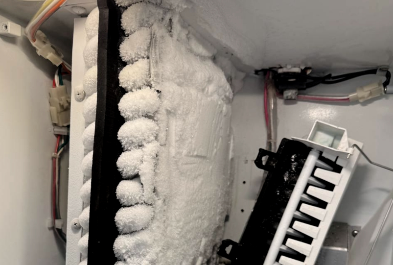 Evaporator coil completely iced over — defrost failure fixed and airflow restored after a full de-ice service in Katy, TX.